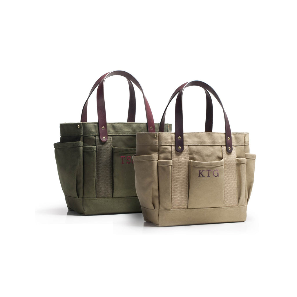 Olive green and khaki tan canvas tool bag with leather handles and monogramming of KTG on front middle pocket