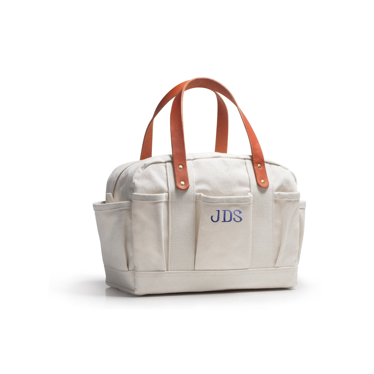 An off-white canvas tool tote bag with brown leather handles and a blue embroidered 'JDS' logo on the front pocket, shown on a white background.