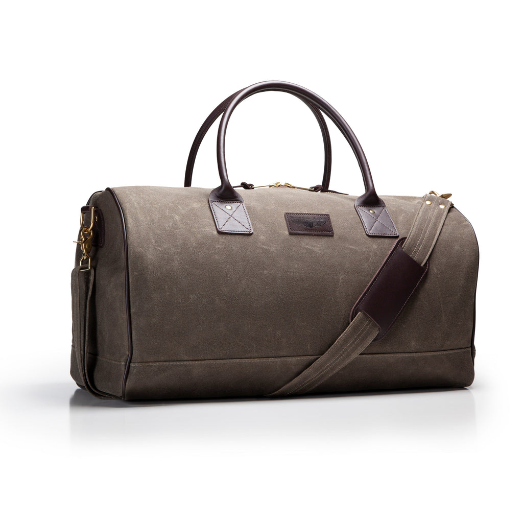Gray duffel bag with black handles and strap on a white background