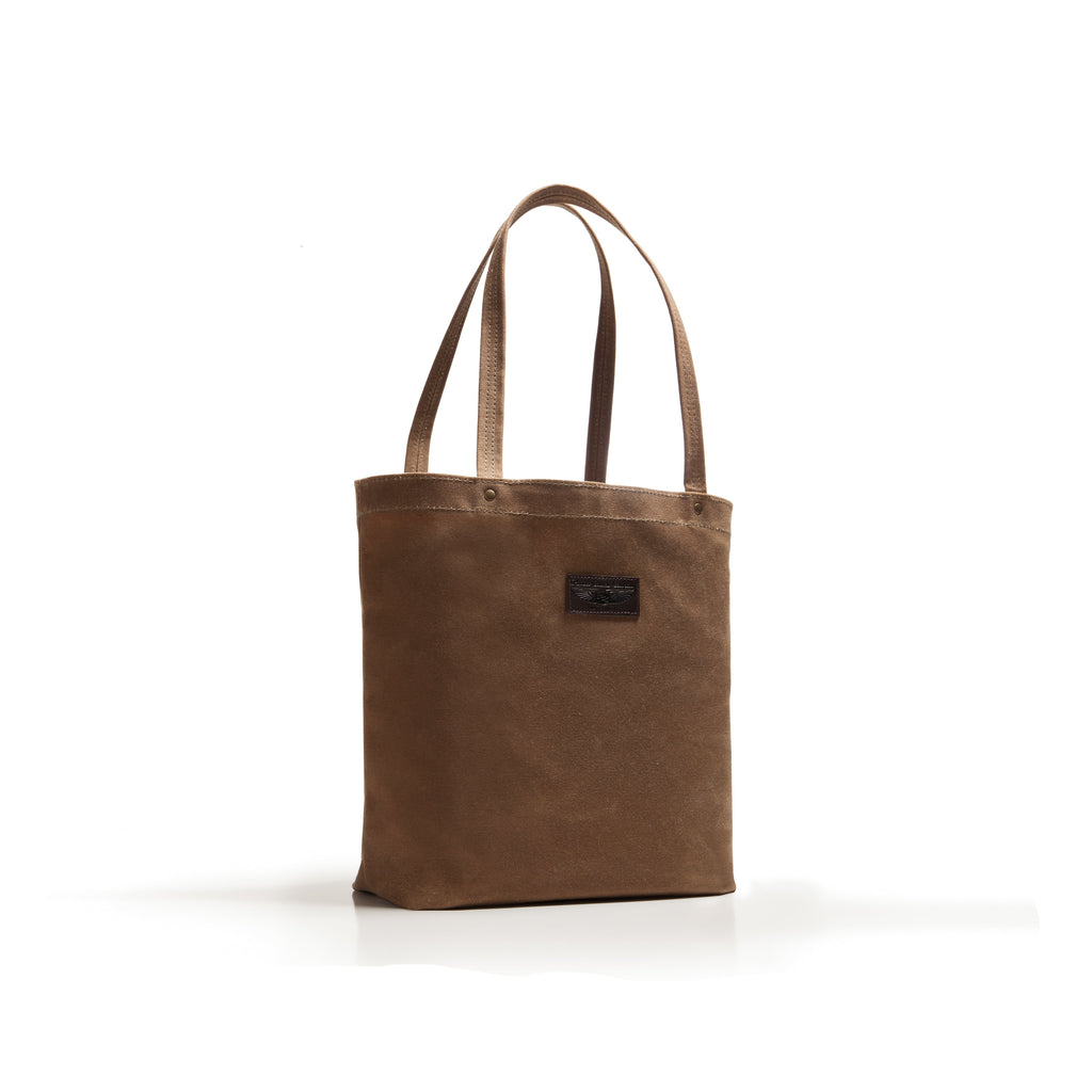 Brown tote bag with a visible brand label on a white background
