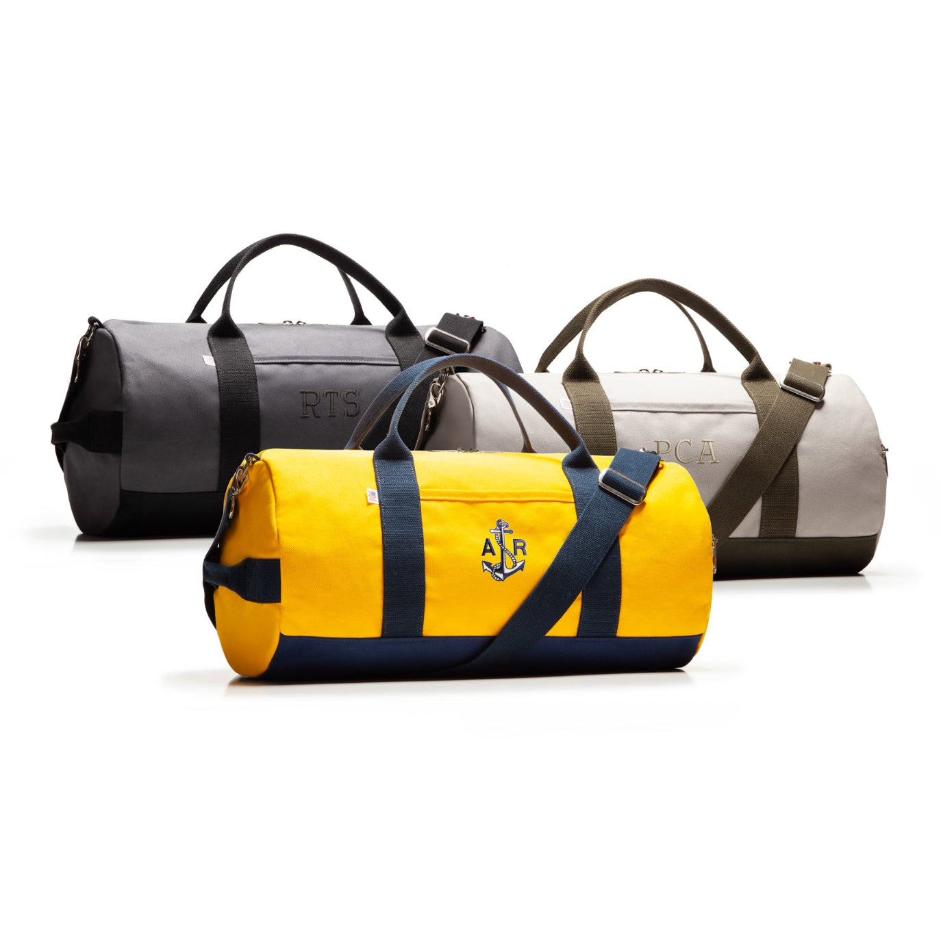 Four duffel bags in different colors on a white background