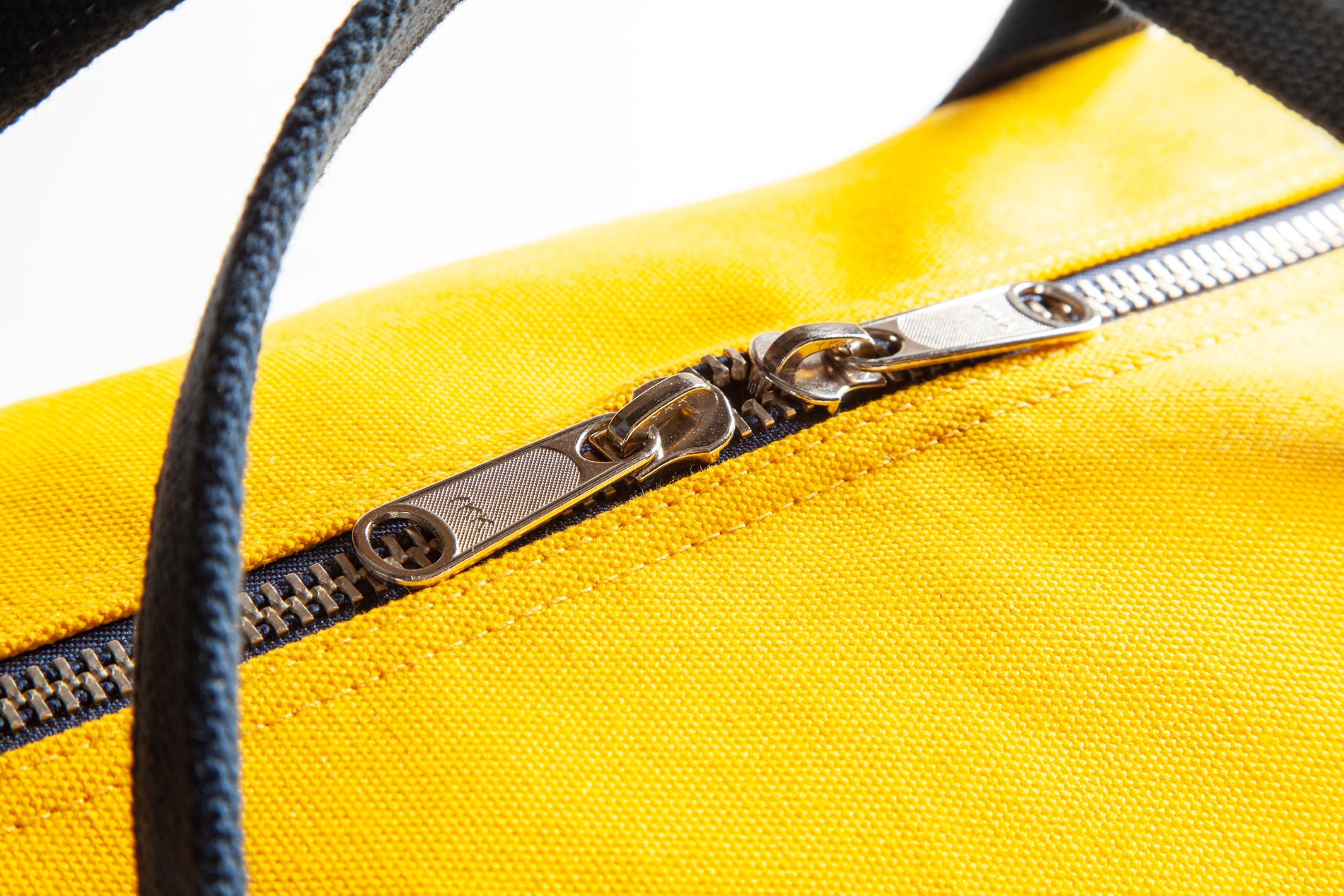 Close-up of a yellow bag with a silver zipper