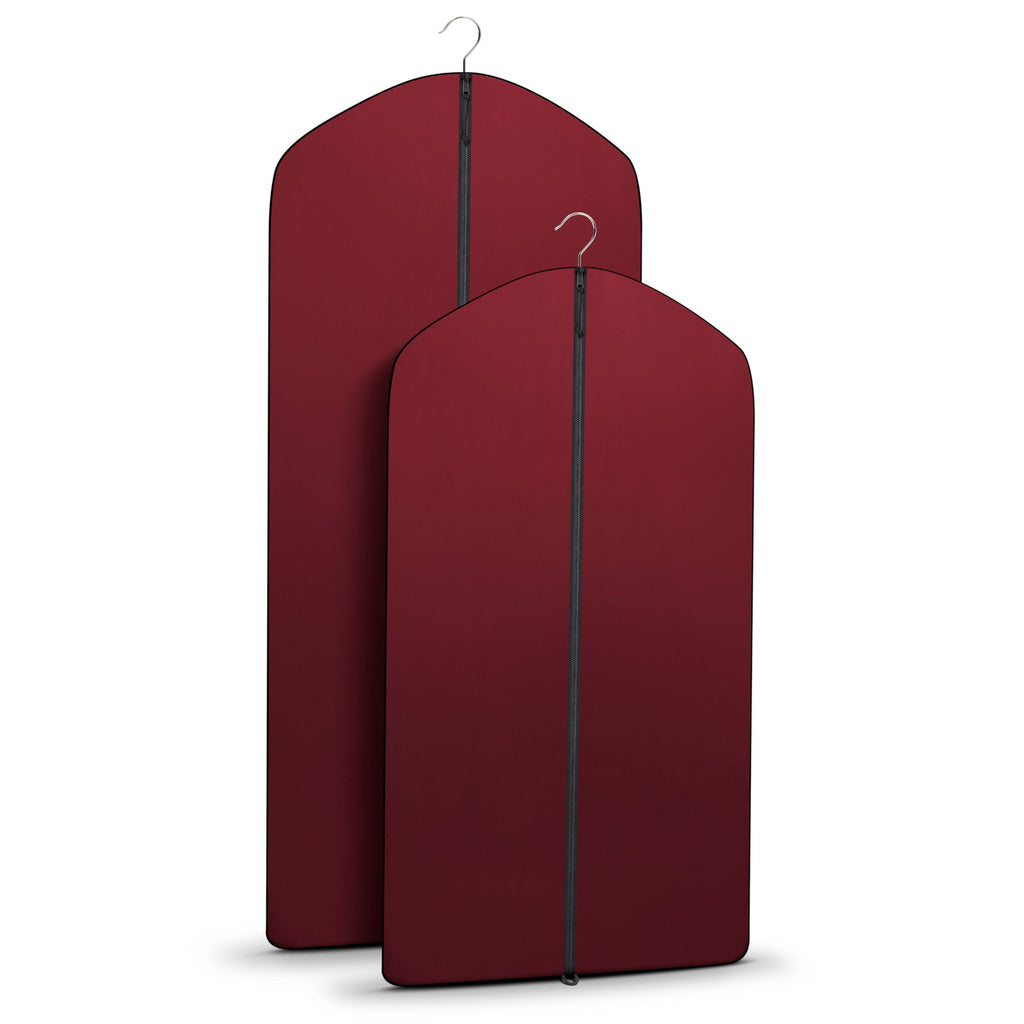 Two burgundy garment bags with hangers on a white background