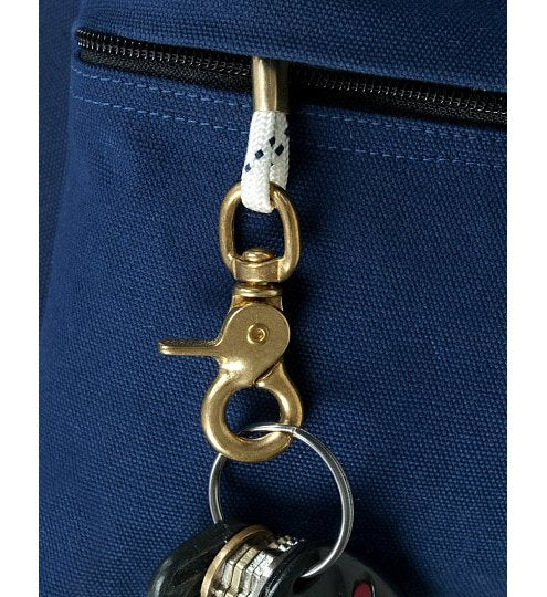 Gold keychain attached to a blue bag with a white rope