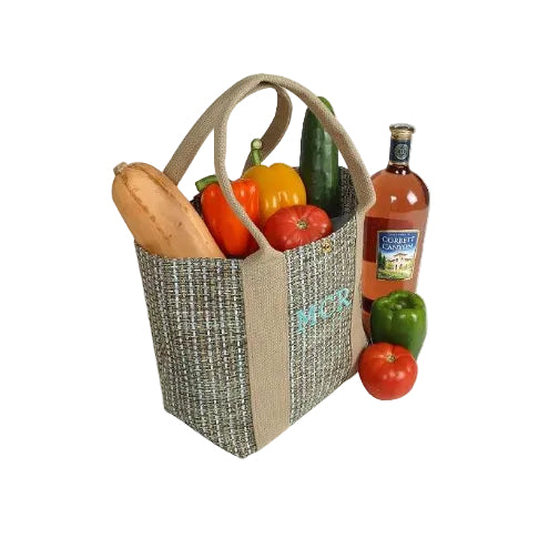 Woven basket with vegetables and a bottle of wine on a white background