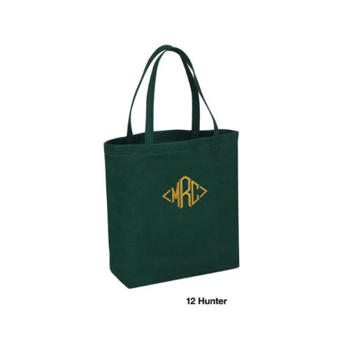 Green tote bag with gold monogram on a white background
