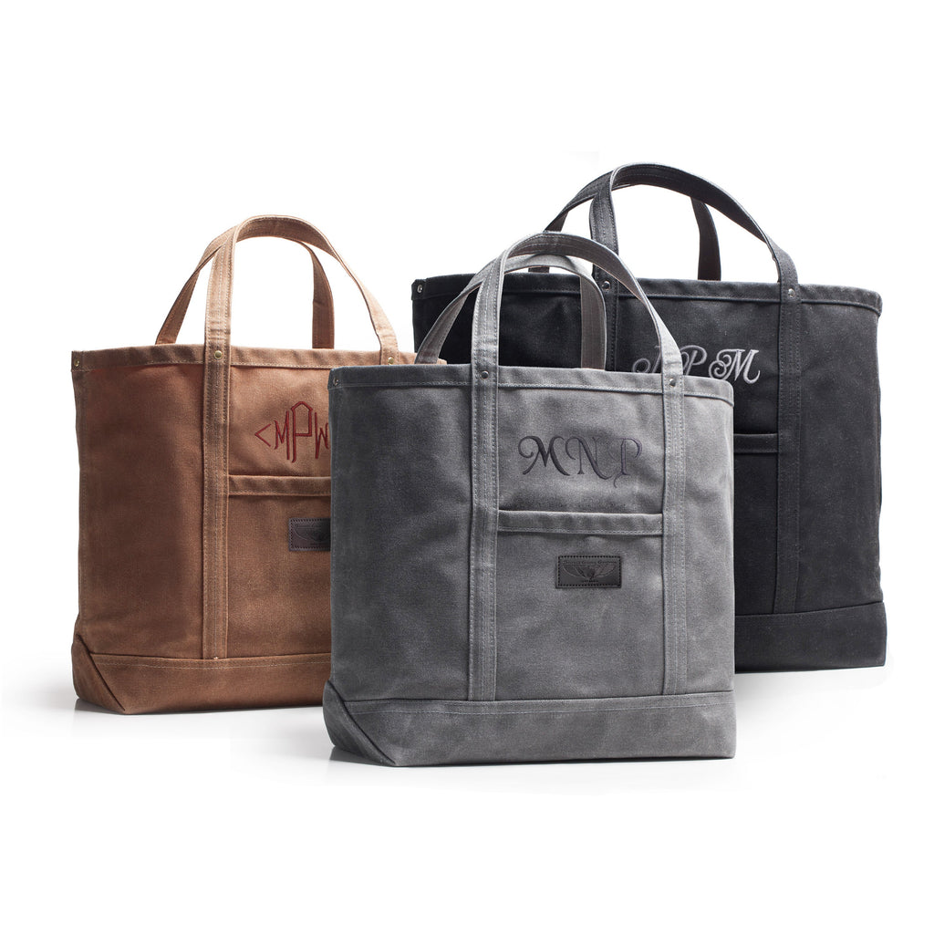 Three tote bags in brown, gray, and black with monogrammed initials on a white background.