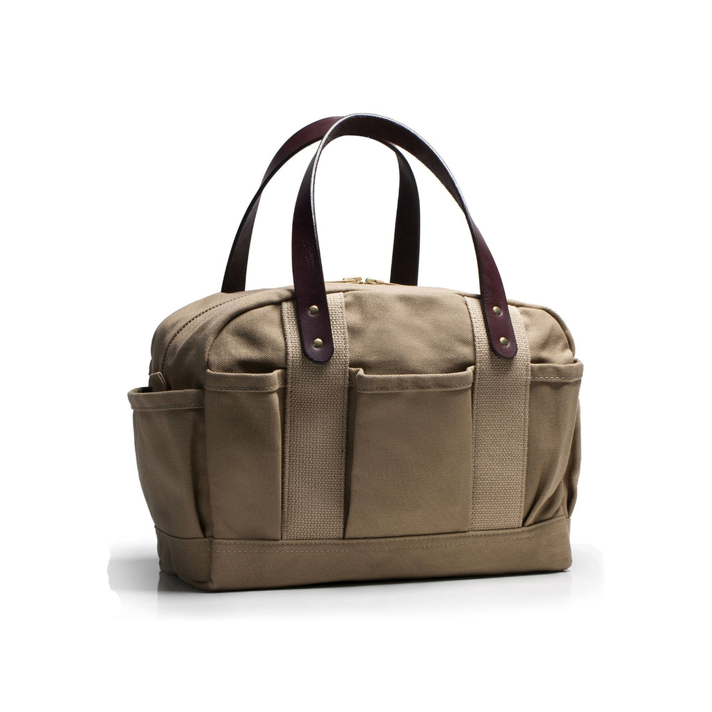 Beige canvas bag with leather straps on a white background