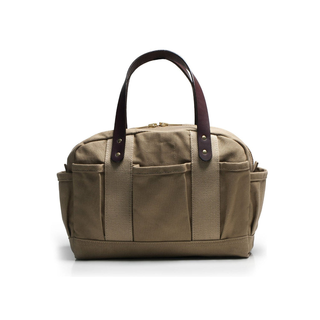 Brown canvas bag with leather handles on a white background