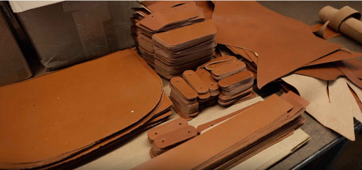 Stacks of brown leather pieces on a table