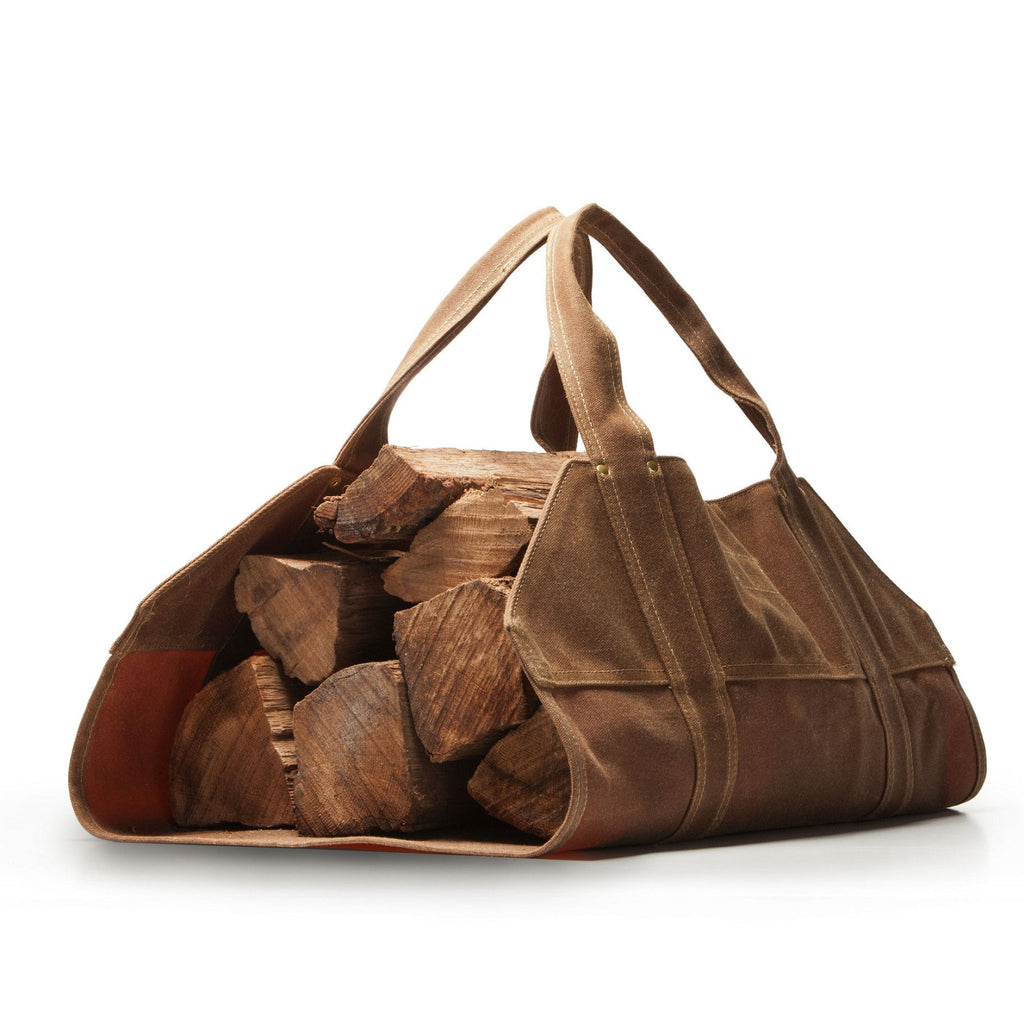 Brown leather bag filled with wooden logs on a white background
