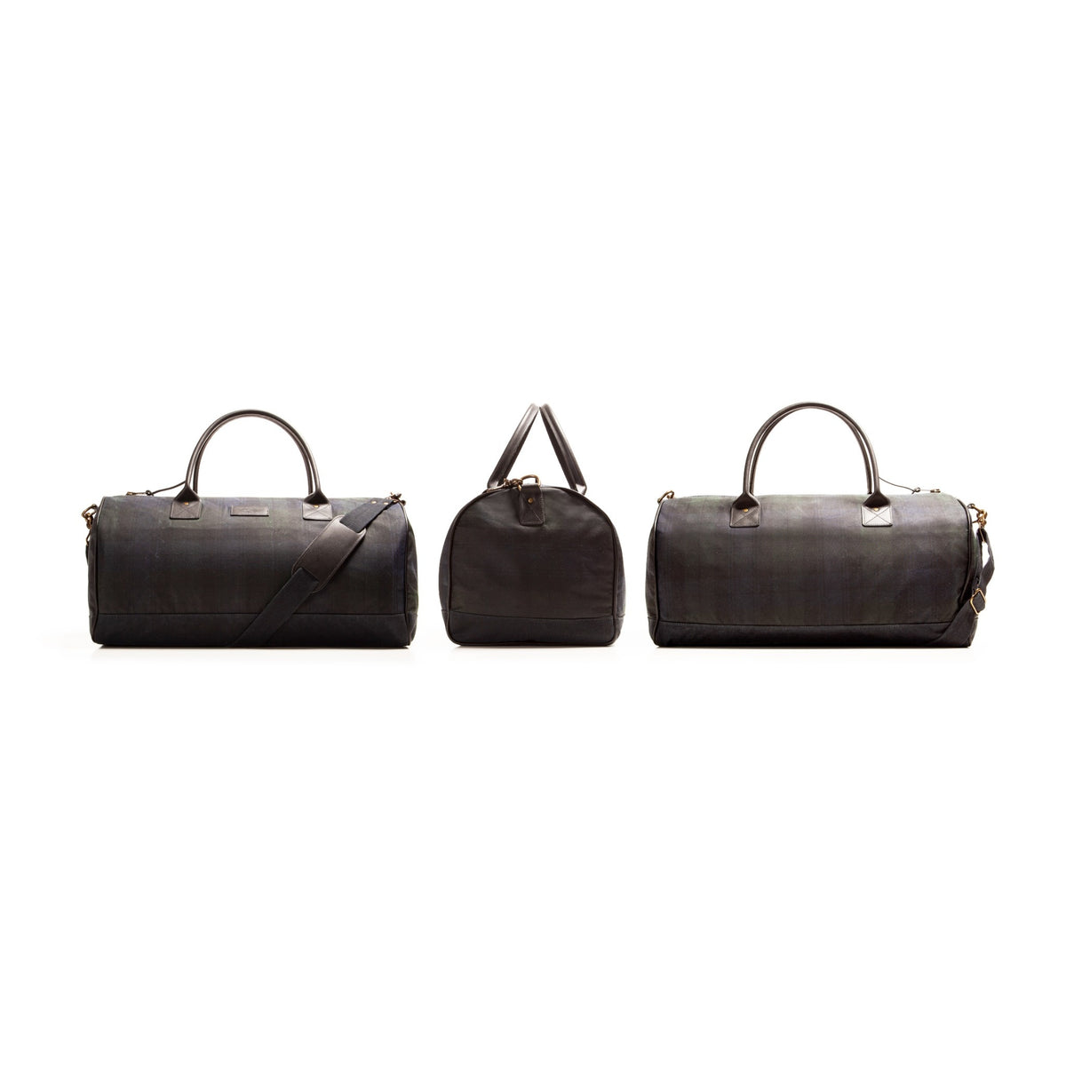 Three angles black and navy plaid wax duck canvas  duffel bag with leather handles and brass accents showing front, side and back angle of the duffle on a white background