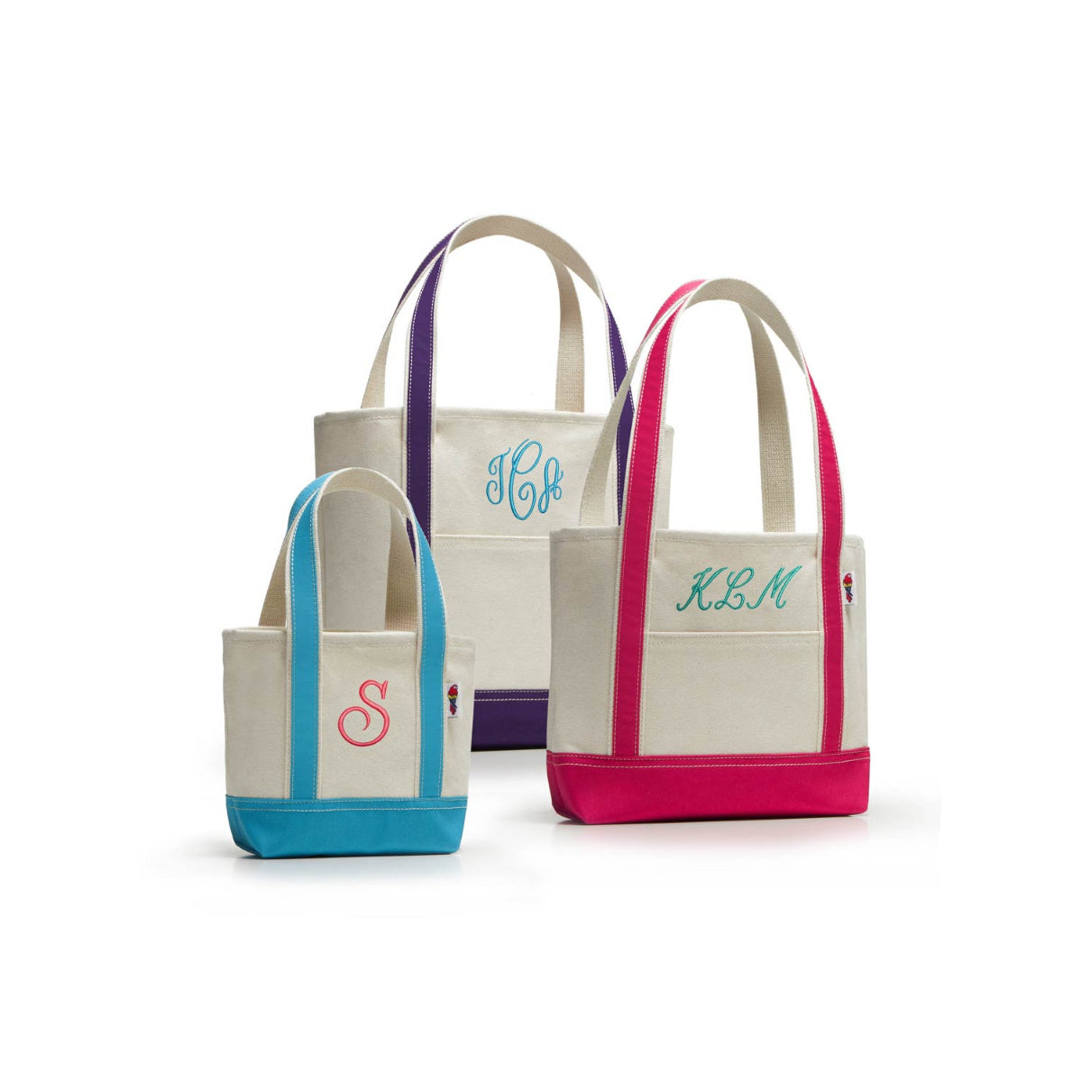 Three canvas tote bags with monograms on a white background