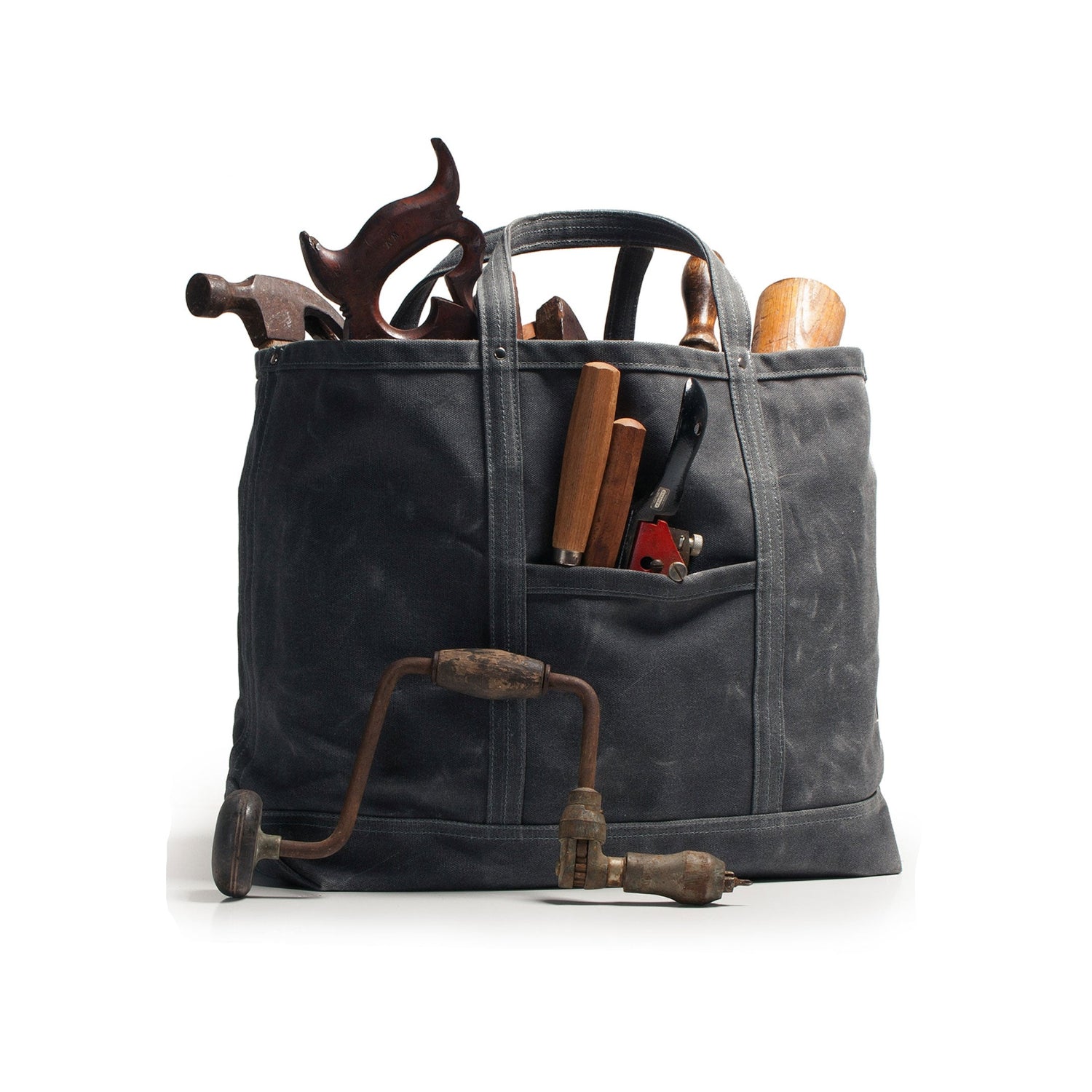 Black canvas tool bag with various tools on a white background