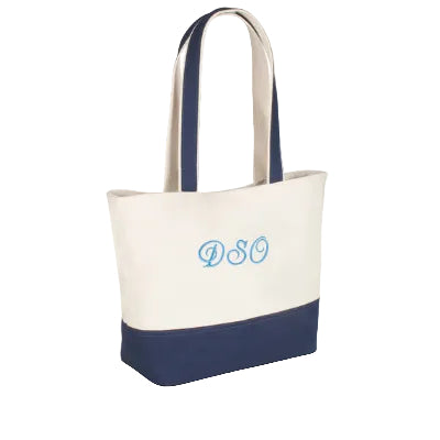 Tote bag with navy bottom half and white top half, featuring the letters 'DSC' in blue.