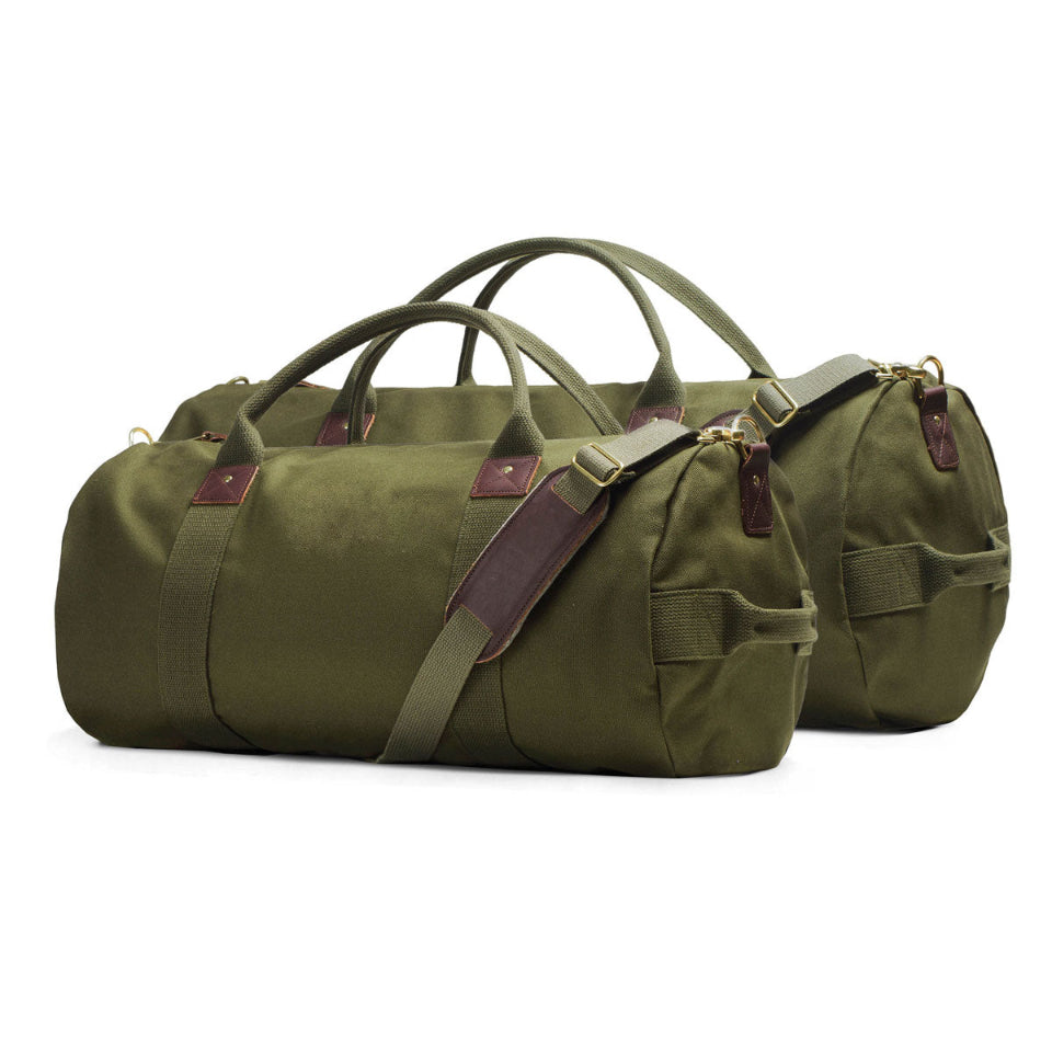 Two green duffel bags with brown straps on a white background
