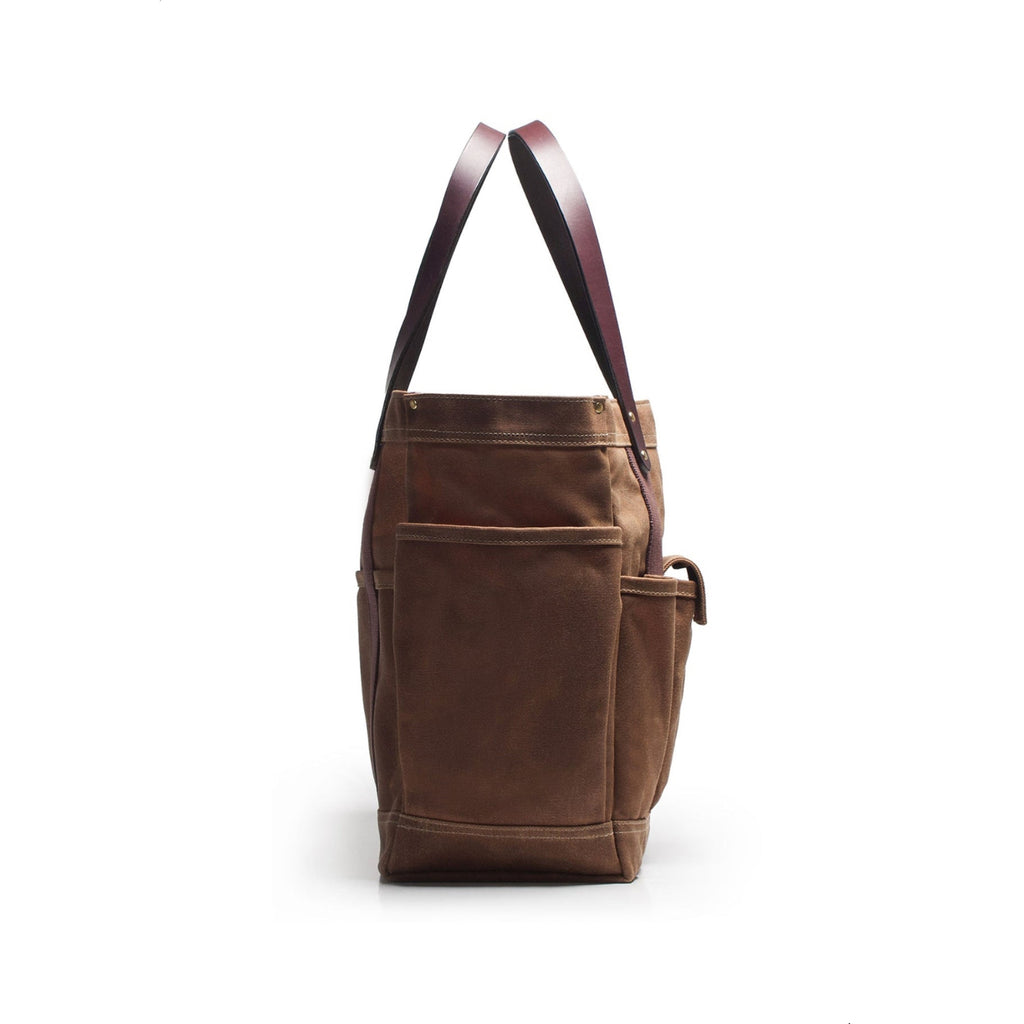 Brown leather tote bag with a strap on a white background