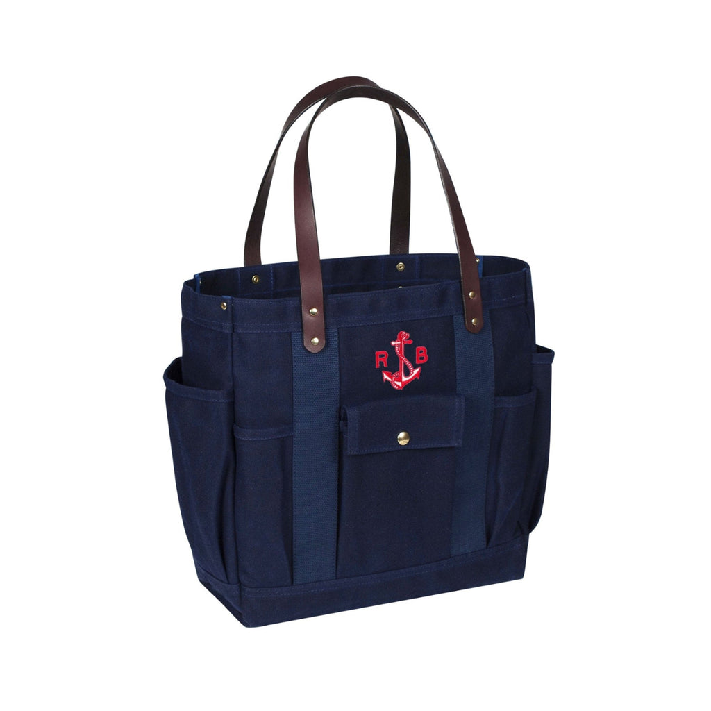 Navy tote bag with brown handles and red anchor design on a white background