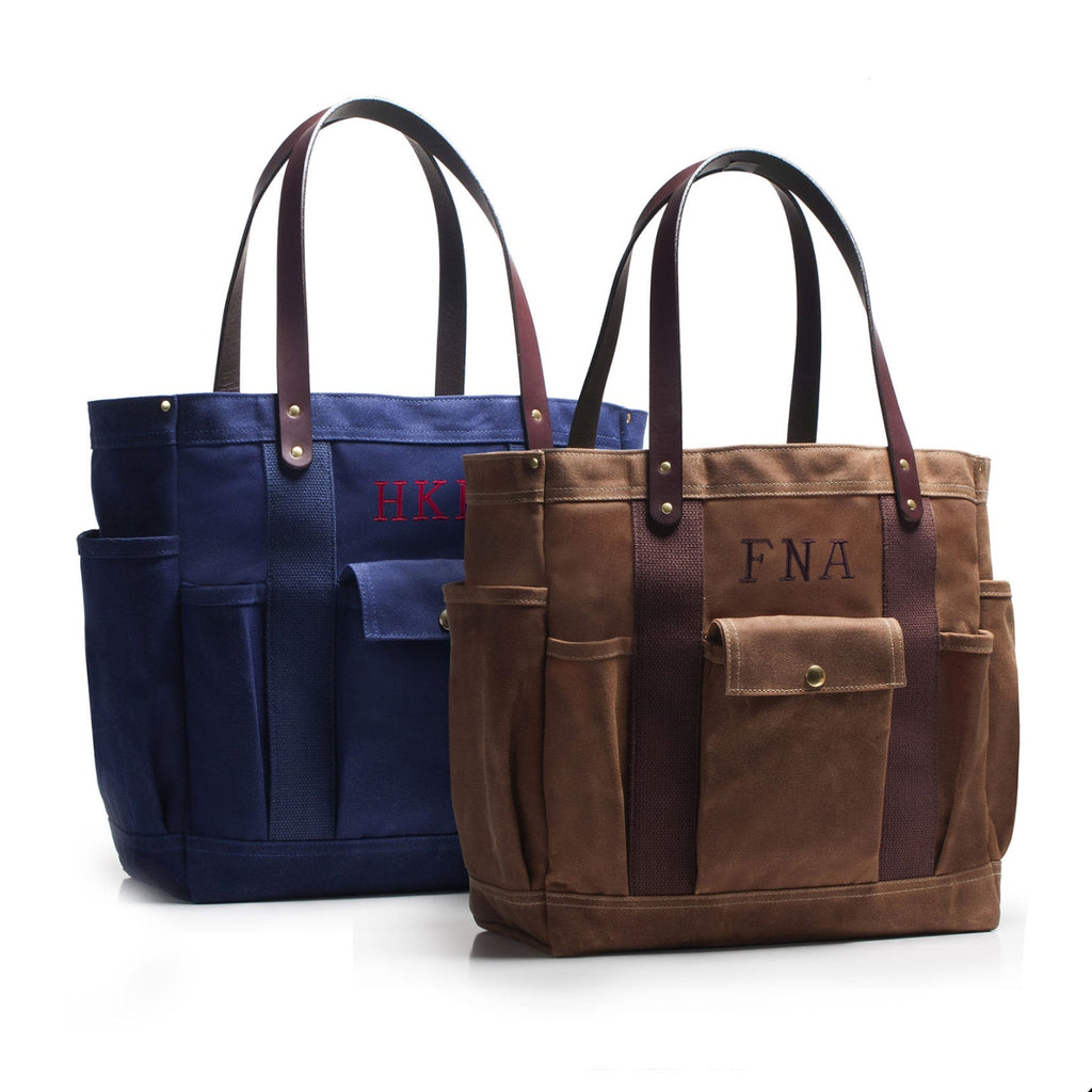 Two tote bags, one blue and one brown, with monogrammed initials on a white background.