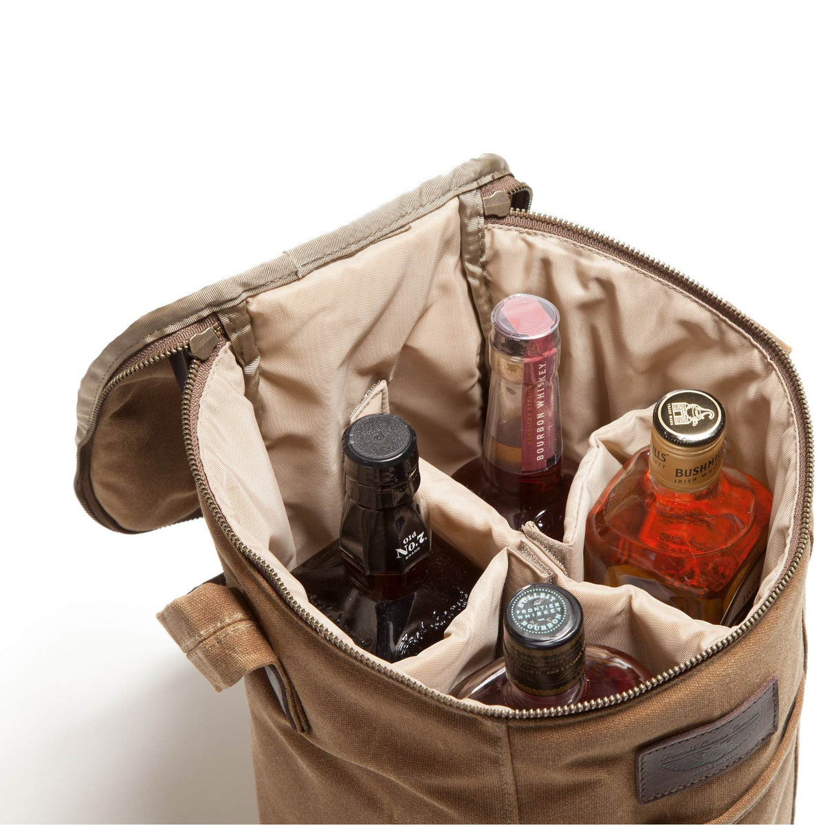 A tan canvas bottle carrier bag with a zippered opening, shown open and filled with several liquor bottles against a plain white background.