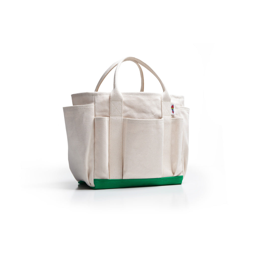 An off-white canvas tote bag with multiple front pockets and a bright green base, shown on a clean white background.